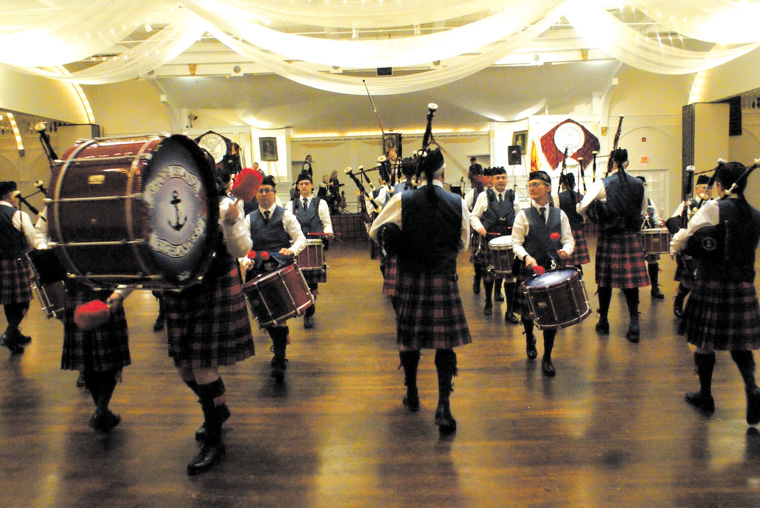 MARCH IN TIME: The Rhode Island Highlanders give an exhibition in a cleared out main hall of Rhodes on the Pawtuxet.